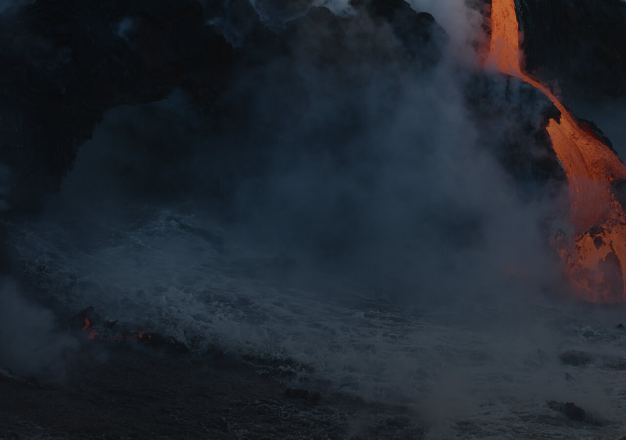 A dramatic ocean scene with lava forming a new land mass.